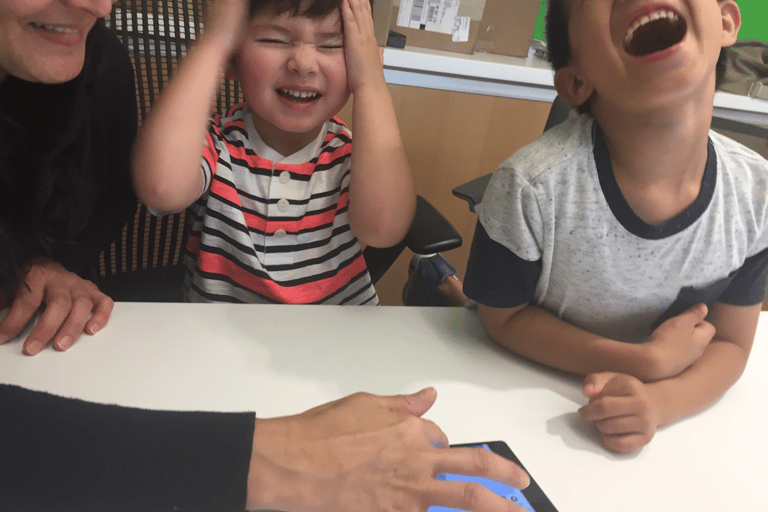 Image of family playing game on tablet