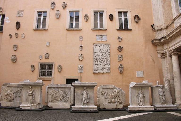 Rome capitolini museum a building with a large stone wall with a large number of statues
