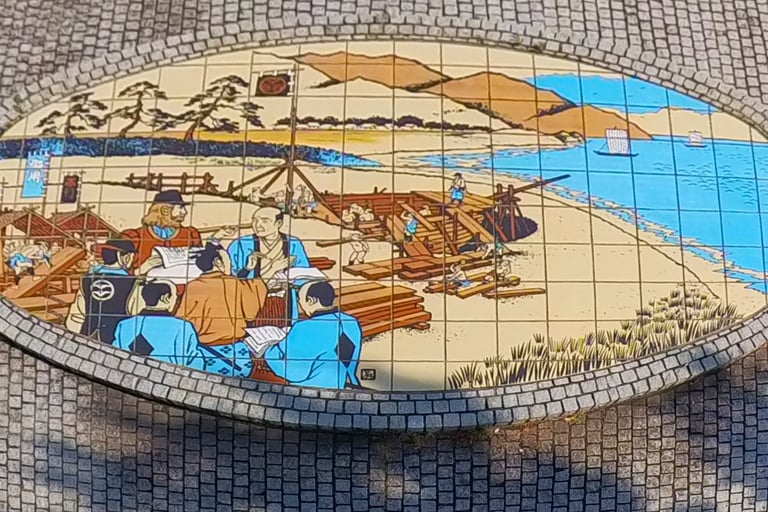 Mural of William Adams overseeing the construction of a western-style sailing ship in Ito.