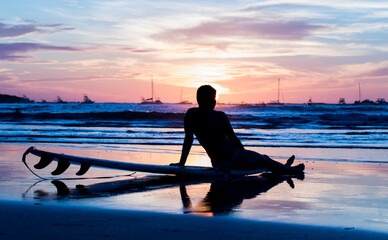 a person sitting on a surfboard in the water