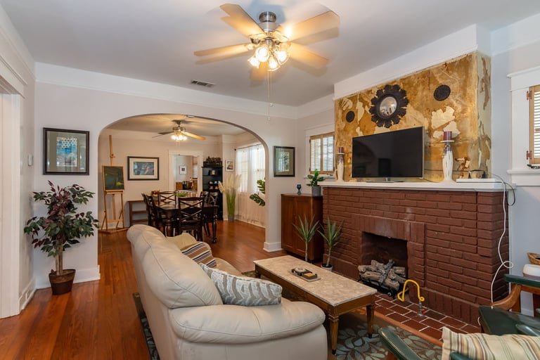 a living room with a fireplace and a television