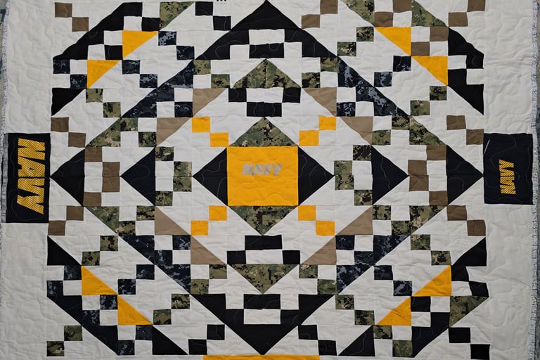 Military uniform memory quilt featuring service patches and uniform pieces arranged into a keepsake 