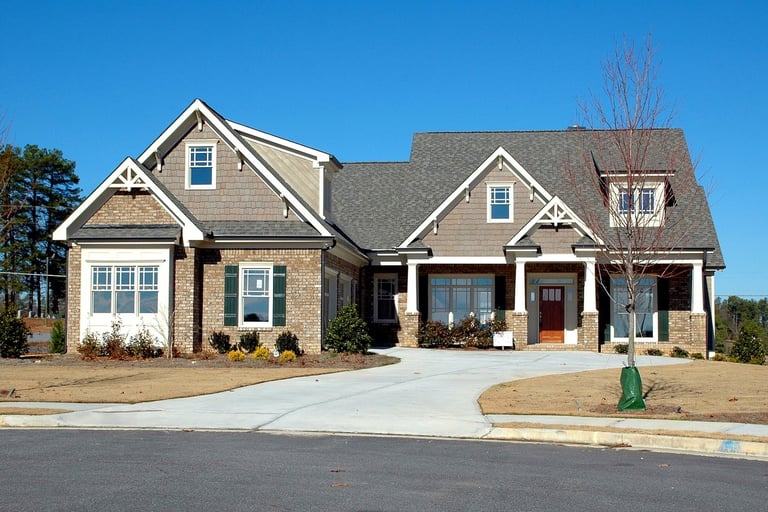 a beautiful house with big driveway and sidewalk