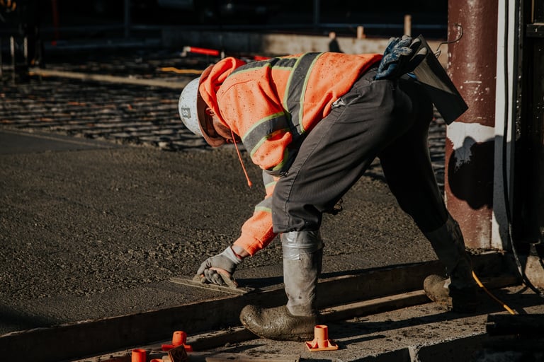 a construction worker is working on a concrete slab