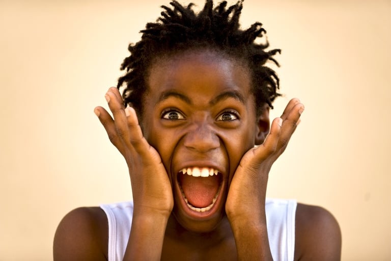 a young girl with her hands on her face