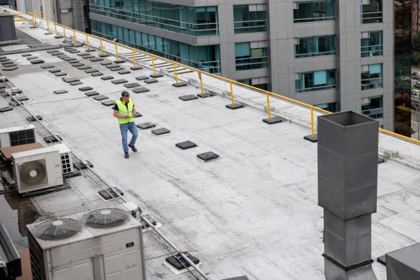 roofer doing an assessment of a commercial roof