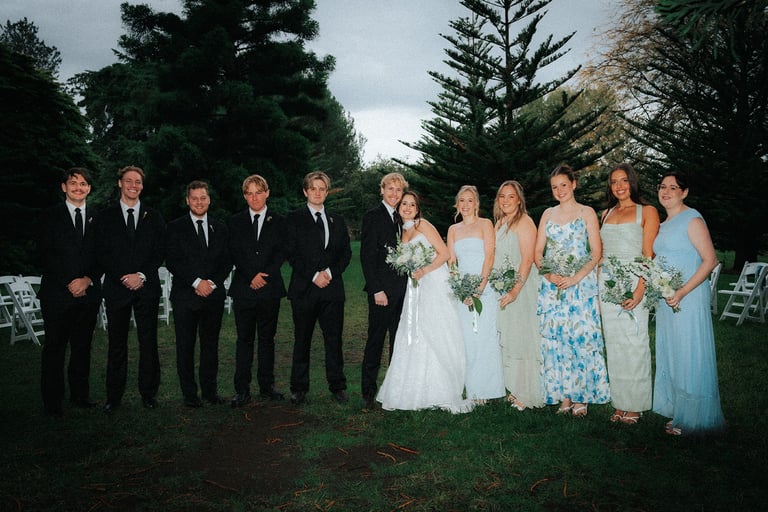 Bride and groom with their bridal party beneath the pine trees at Adelaide Botanic Garden