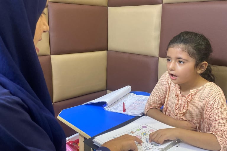 Therapist guiding young girl during session
