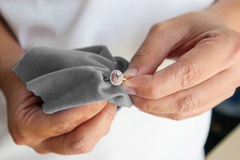a woman carefully polishing a cremation ashes ring