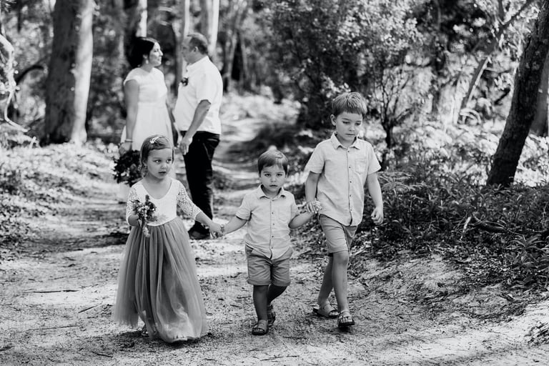 Children participating in a joyful Noosa Sunshine Coast Briabane wedding ceremony Noosa beach 