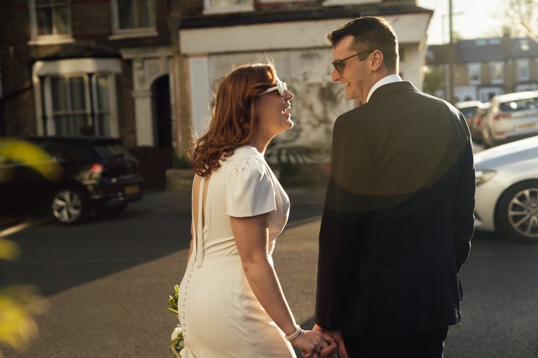 bride smiling and groom during sunset golden hour
