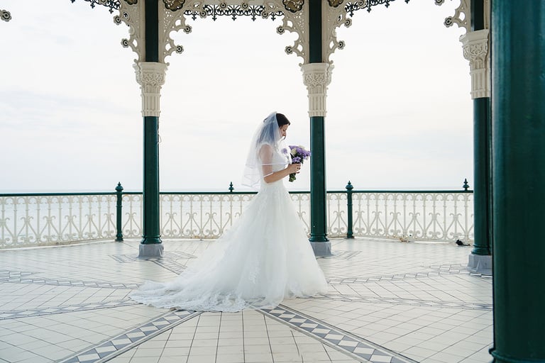 Bride holding her flowers and standing in her dress