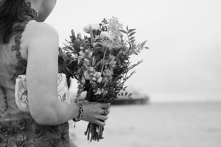 black and white image with woman hand holding flowers