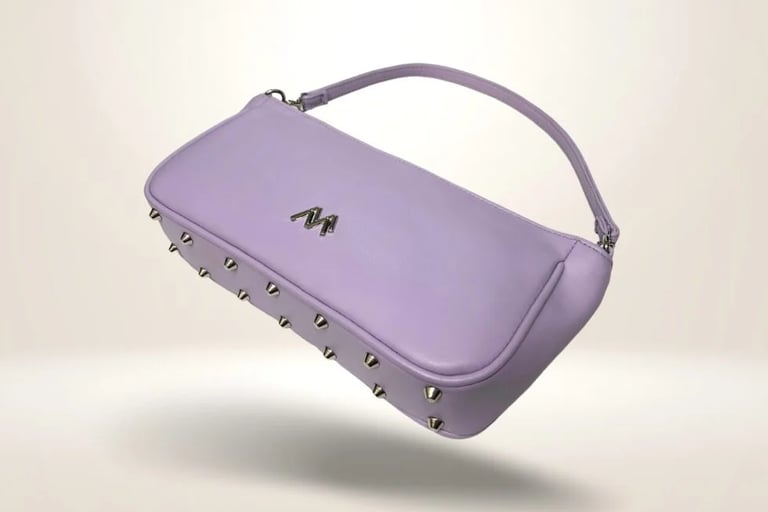 A stylish lavender leather baguette handbag with silver metal studs and a matching shoulder strap.