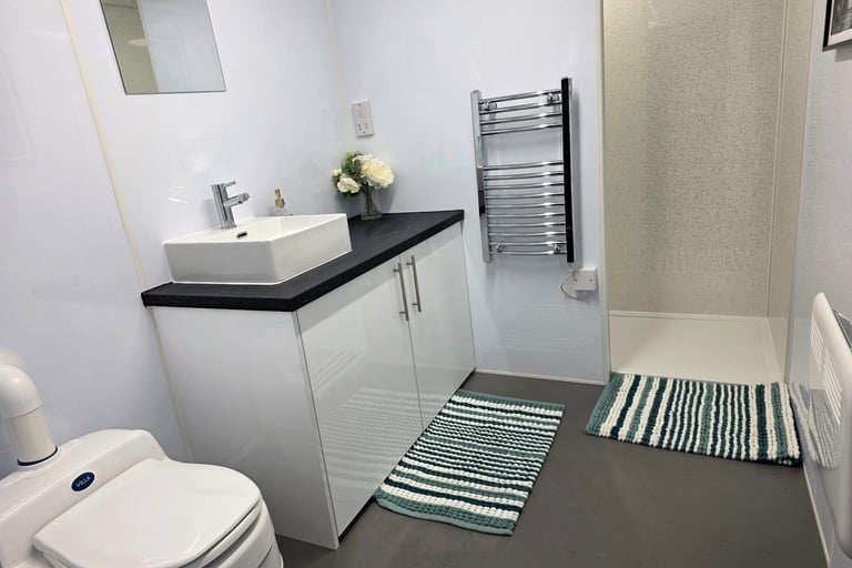Full interior of a modern temporary bathroom pod available for rental during insurance claims and renovation projects.