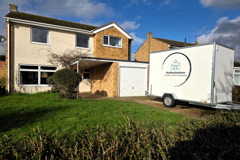 Temporary kitchen and bathroom pod installed on a residential driveway for home renovation works.