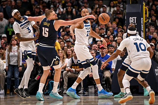 APRIL 27: Nikola Jokic (15) of the Denver Nuggets gets a hand on the ball as Jaden McDaniels, Rudy Gobert and Mike Conley