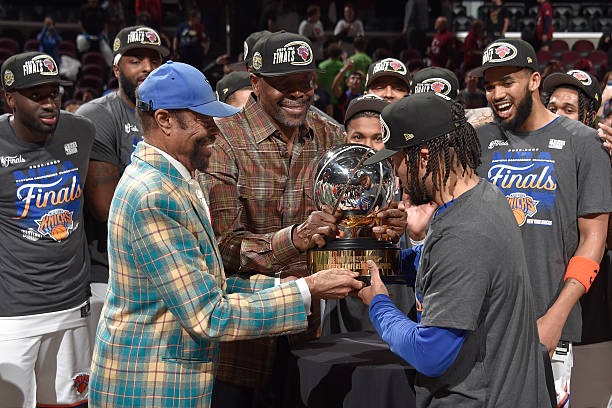 Clyde Frazier (left) Patrick Ewing (middle) and Jalen Brunson (right) holding the ECF MVP trophy (May 25, 2026)