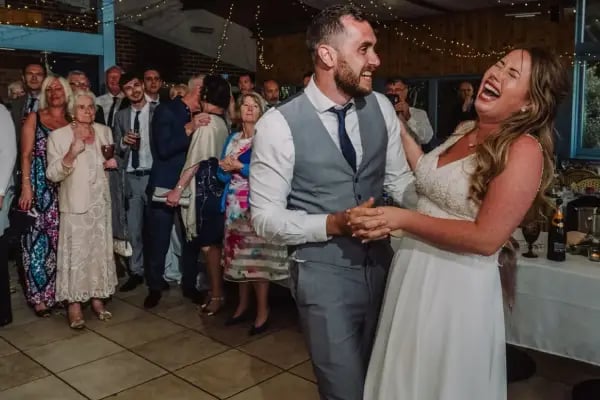 A bride and groom dancing to a high-energy live set from Mosaic wedding band