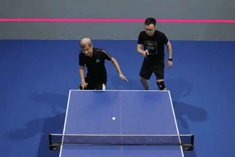 Senior table tennis coaching session supporting balance, mobility, and social connection