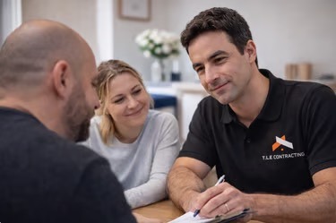 T.LE Contracting builder with a couple in their kitchen to discuss a quote and answer construction questions in Brighton.