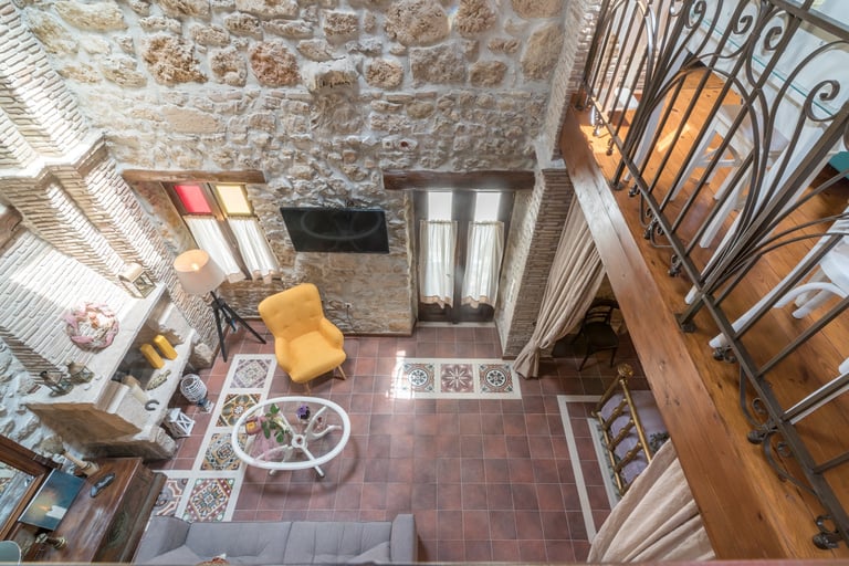 open space interior of two floor stone house Villa Galanoussa Zakynthos