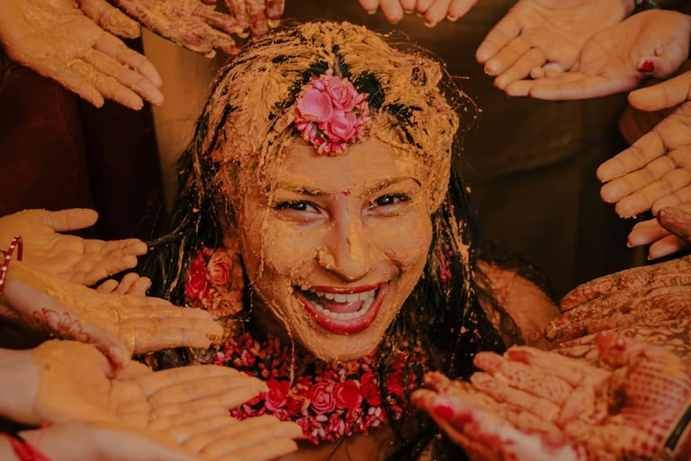 Indian Haldi ceremony with turmeric paste applied to skin, traditional skincare ritual before wellni