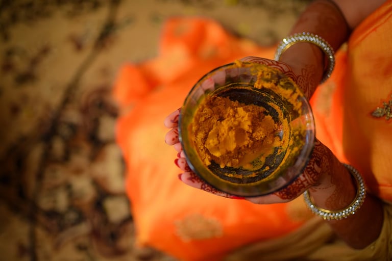 DIY turmeric and besan face pack with rose water in ceramic bowl, natural Indian skincare treatment