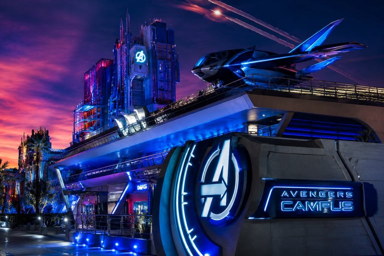 Avengers Campus at night featuring the Quinjet and illuminated logo at Disney California Adventure Park.
