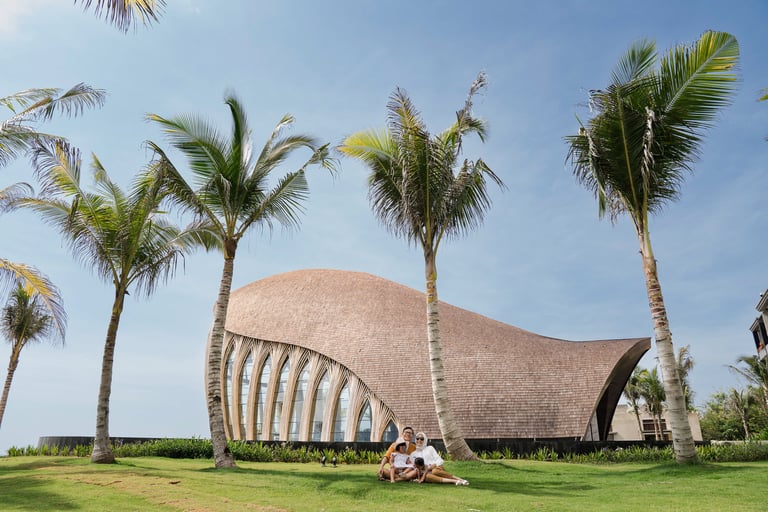Family portrait during a family photography session at  Front of Chapel The Apurva Kempinski Nusa dua Bali.