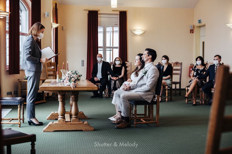Bride and groom listening to the wedding officiant at the Ahrensfelde civil registry.