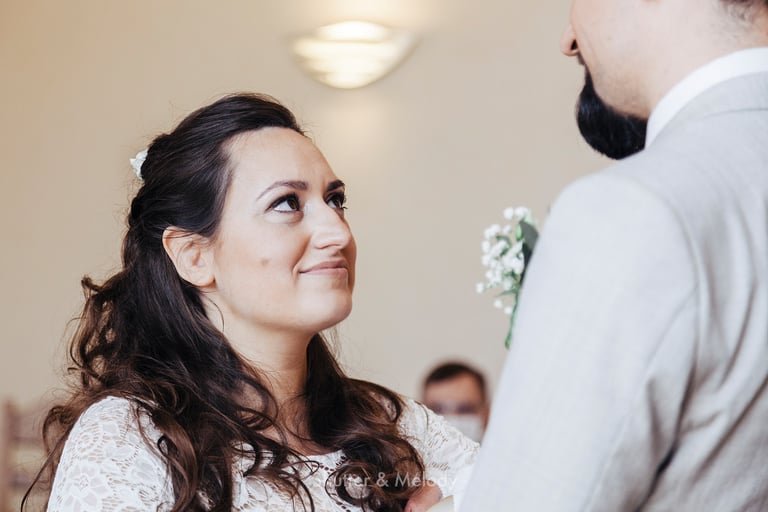 Bride looking at groom during wedding ceremony.