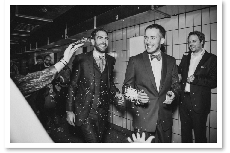 Two grooms during a send off in a club.