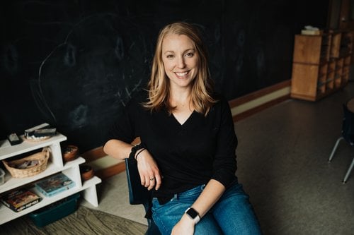 a woman sitting on a chair in a room