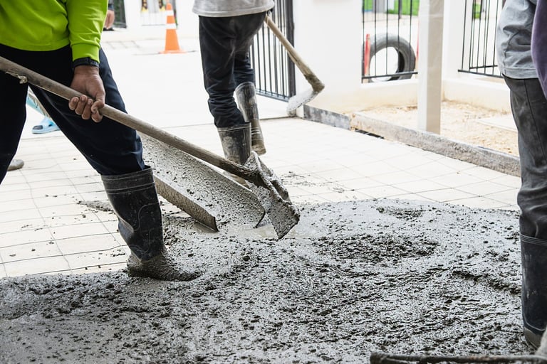 men mixing and pouring concrete