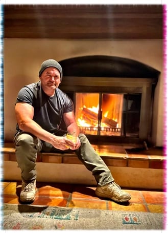 Alfred, co-owner of Green Bee Laser Cleaning & Restoration, relaxing by a fireplace