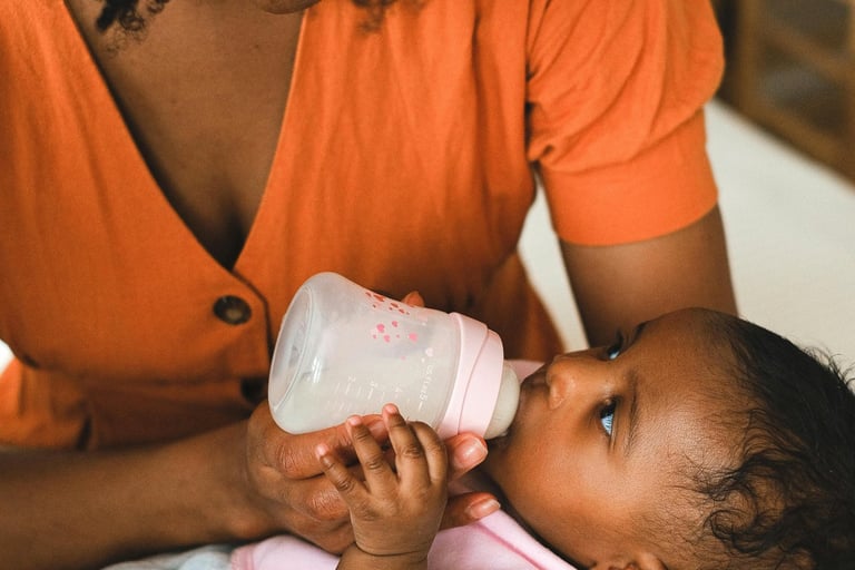 Baby feeding station with bottles, pump, and burp cloths
