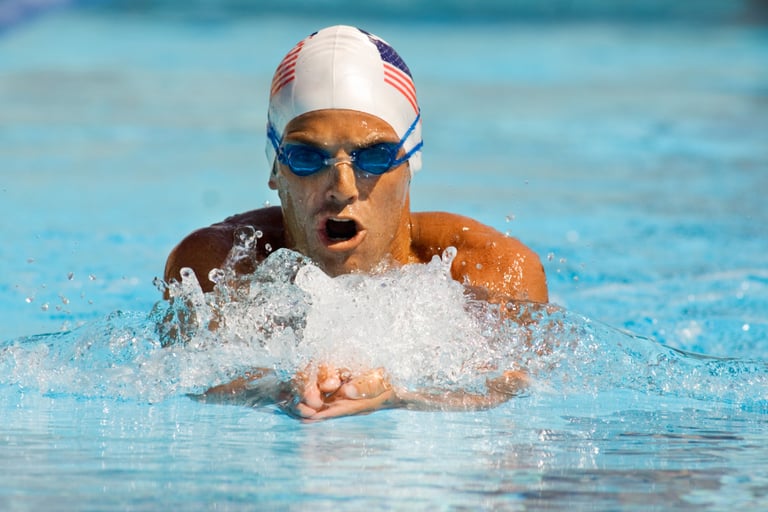 a swimmer in a swimming pool with a usa flag on his head
