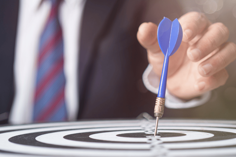 a man in a suit and tie is holding a dart dart dart in the center