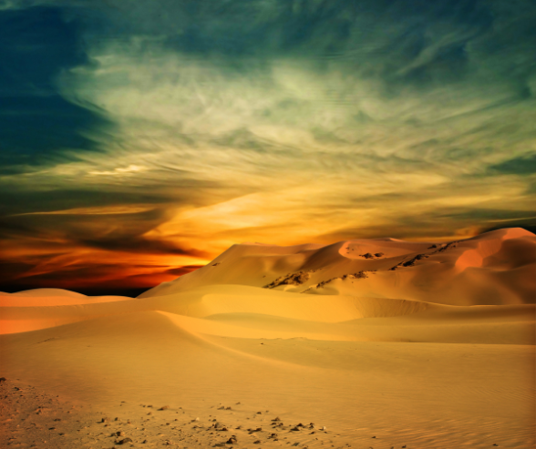 a person walking through a desert landscape with a sunset