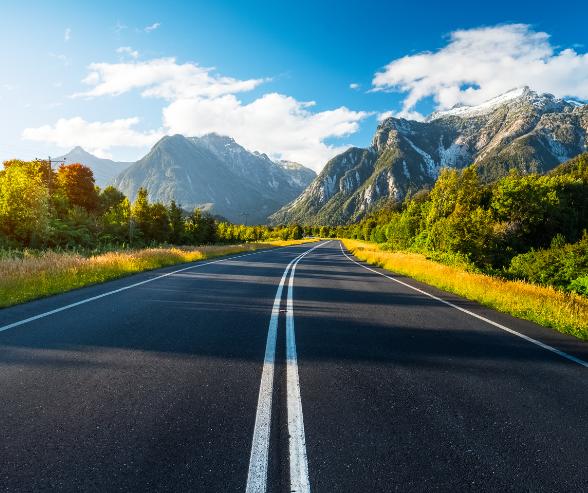 a road with a mountain in the background