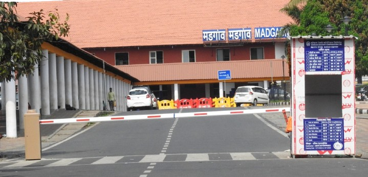 a gated entrance to a Margao railway station building with a sign board of Margao