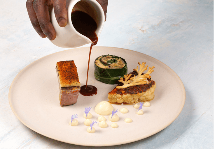 Beachfront dining experience at the Barbados Food and Rum Festival with chefs preparing gourmet dish