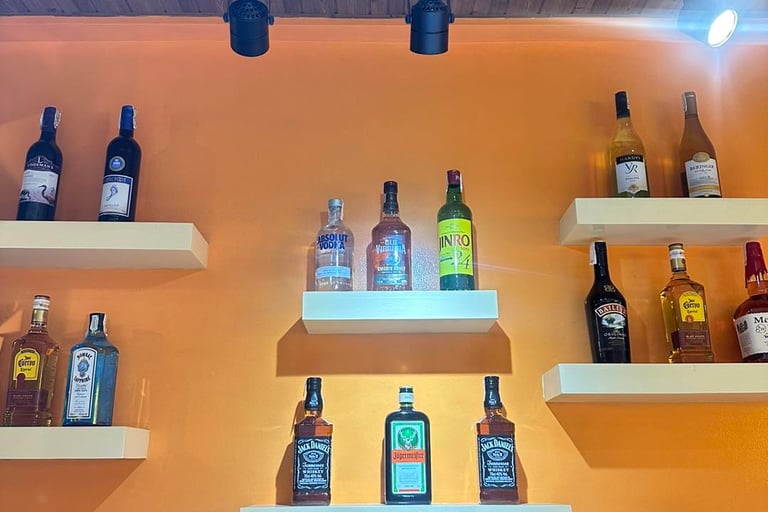 stock of alcoholic drinks displayed at the bar of Ameia