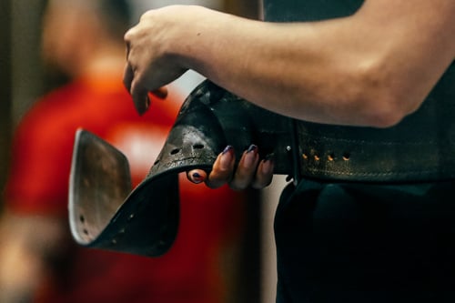 a young lady wearing a lifting belt