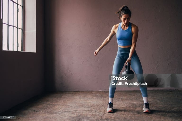 a woman holding a kettlebell