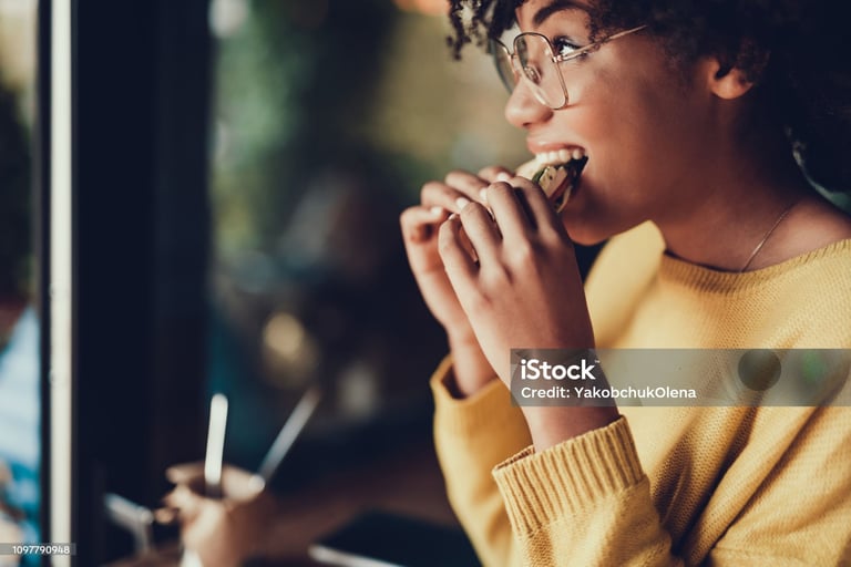 a woman eating a sandwich in a restaurant