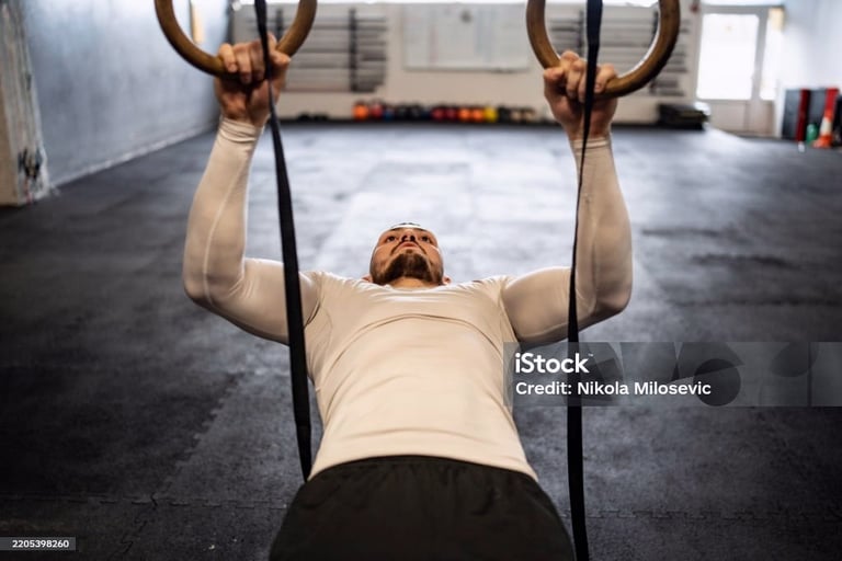 a man doing a pull up barbell in a gym