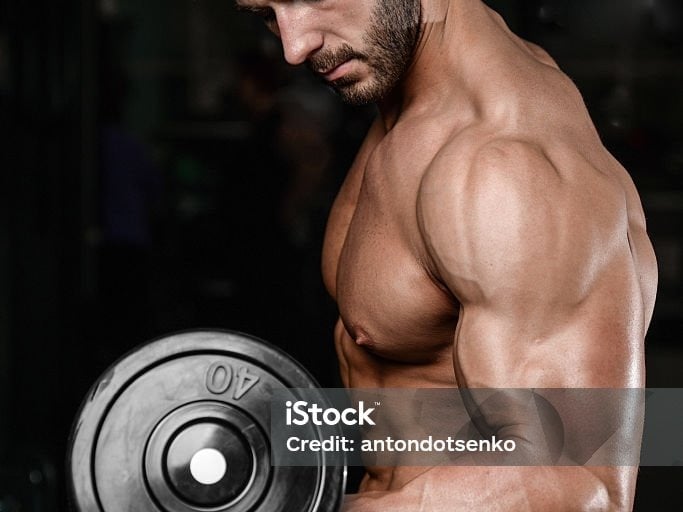 a man with a dumbbell in his hand