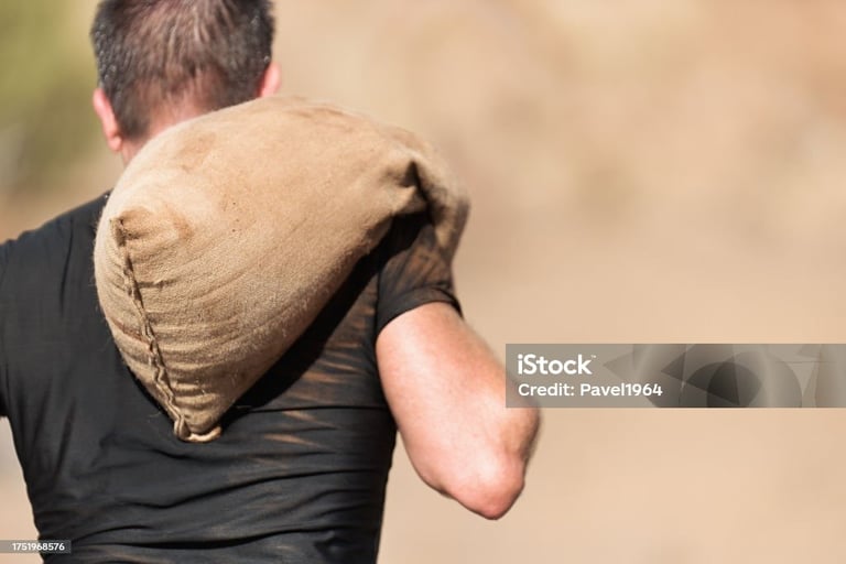 a man carrying a sandbag